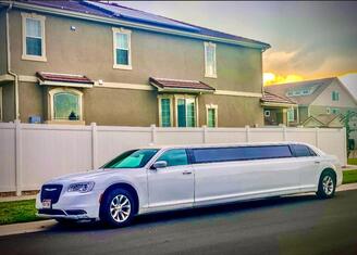 This is a picture of a white stretch limo outside a house ready to pick up our limo passengers in Parker, COcture